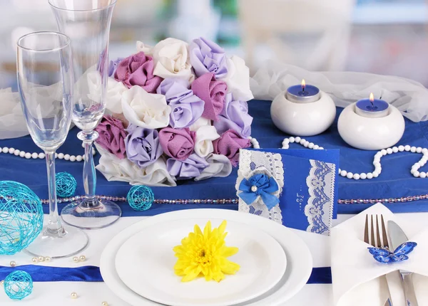 Serving fabulous wedding table in purple and blue color of the restaurant b