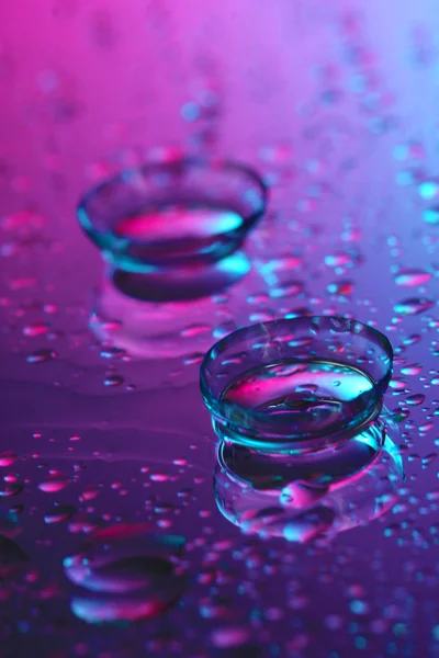 Contact lenses, on pink-blue background