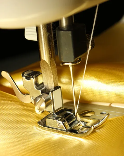 Sewing machine with gold cloth closeup