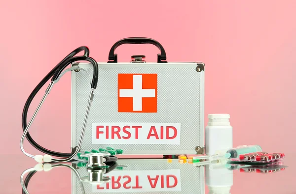 First aid box, on pink background