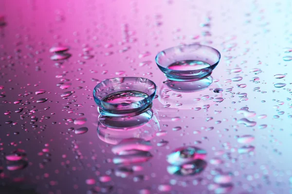 Contact lenses, on pink-blue background