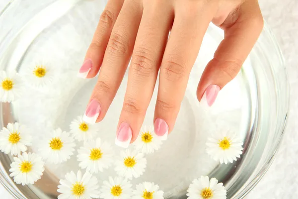 Water treatment for female hands, close-up