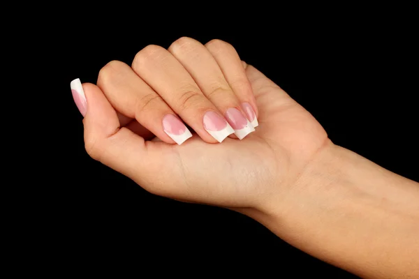 Beautiful woman\'s hand with french manicure on black background