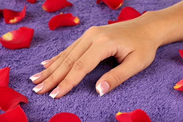 Woman's hand on purple terry towel, close-up