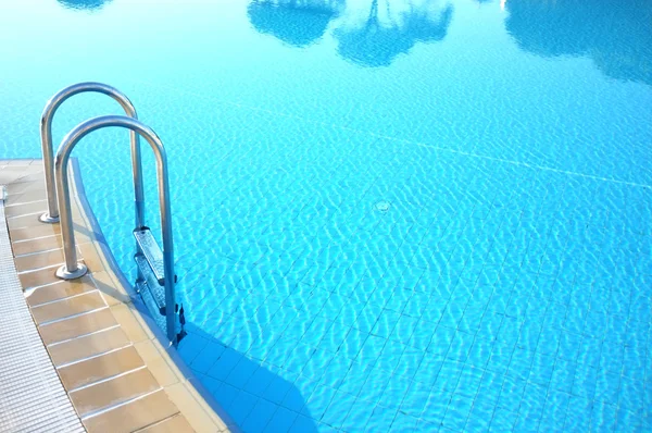 Hotel swimming pool with sunny reflections