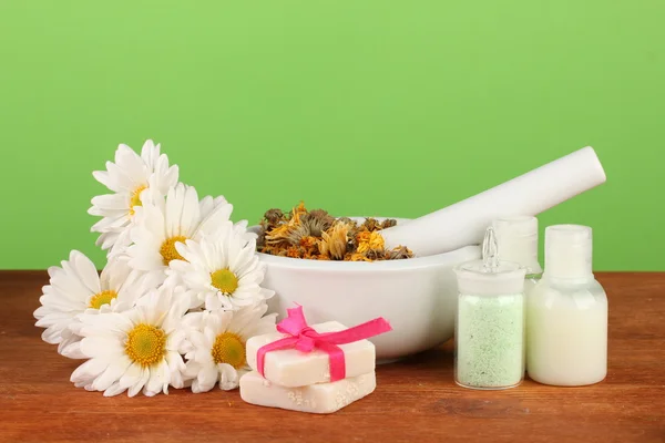 Ingredients for soap making on green background