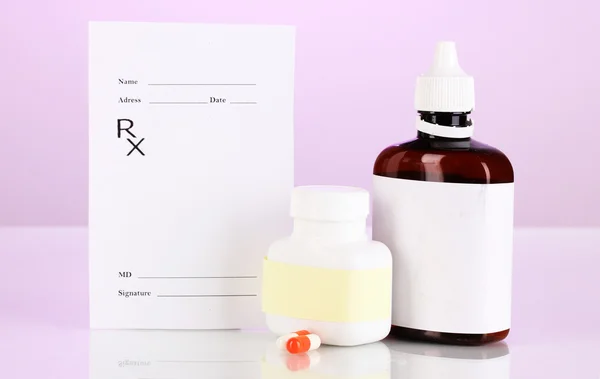 Pharmacist prescription with drops and pills isolated on purple