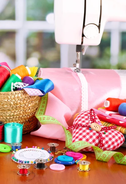 Sewing machine and fabric on bright background