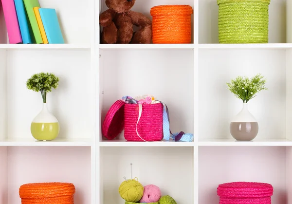 Color wicker boxes on cabinet shelves