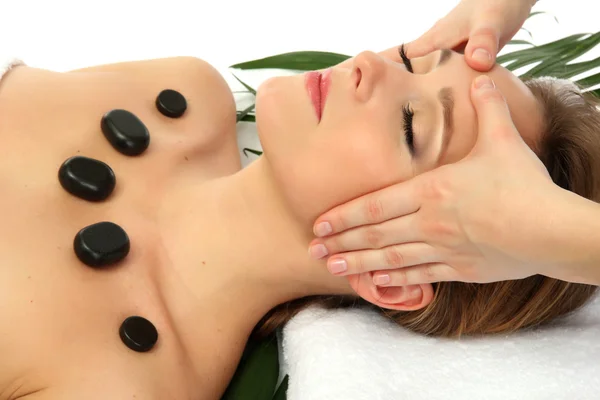 Portrait of beautiful woman with spa stones taking head massage