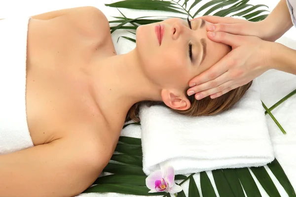 Portrait of beautiful woman in spa salon taking head massage