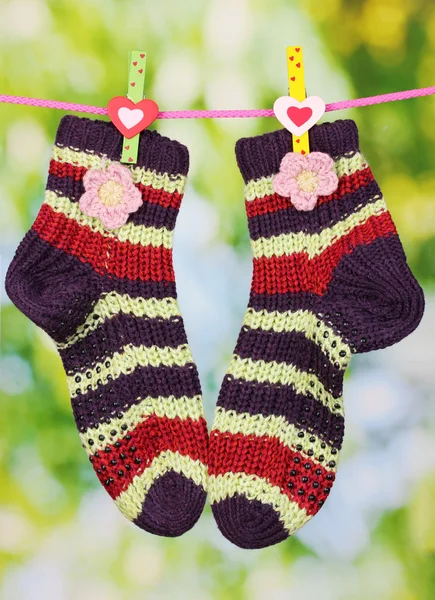 Pair of knit striped socks hanging to dry