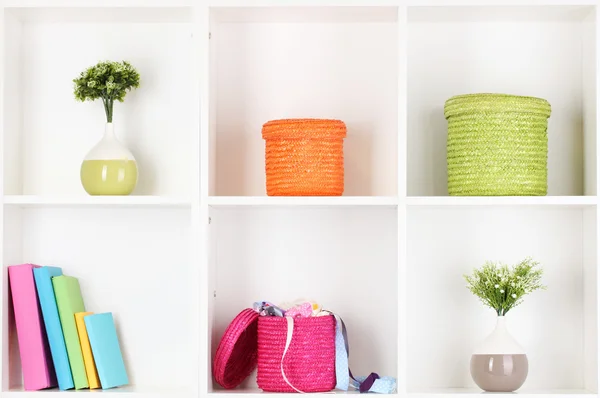 Color wicker boxes on cabinet shelves