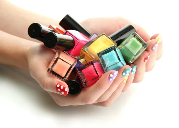 Woman hands with nail polishes isolated on white