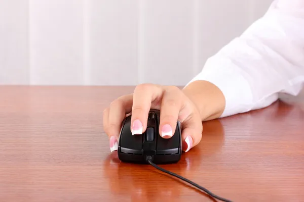 Woman's hands pushing keys of pc mouse, close-up