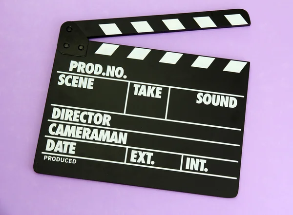 Movie production clapper board on color background