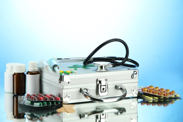 First aid box, on blue background