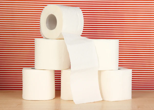 Rolls of toilet paper on striped red background