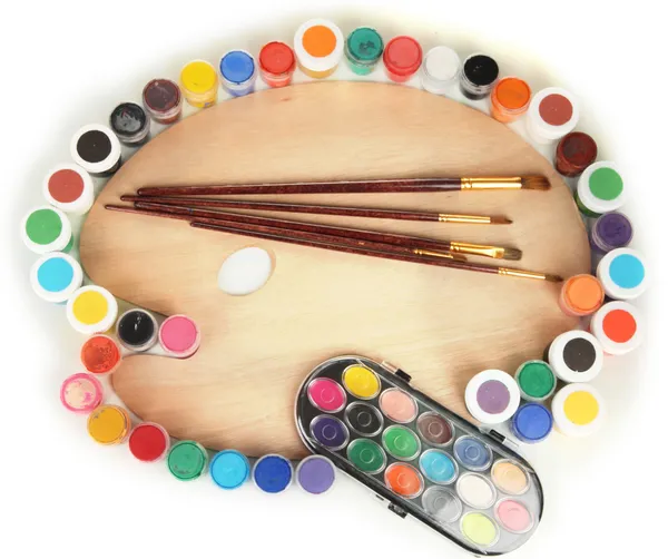 Wooden art palette with brushes for painting and paints isolated on white