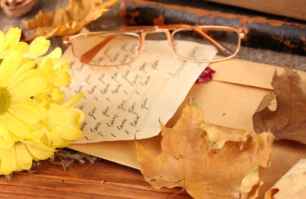 Autumn background:romantic letter, glasses and leaves