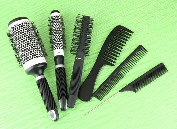 Black combs on color background