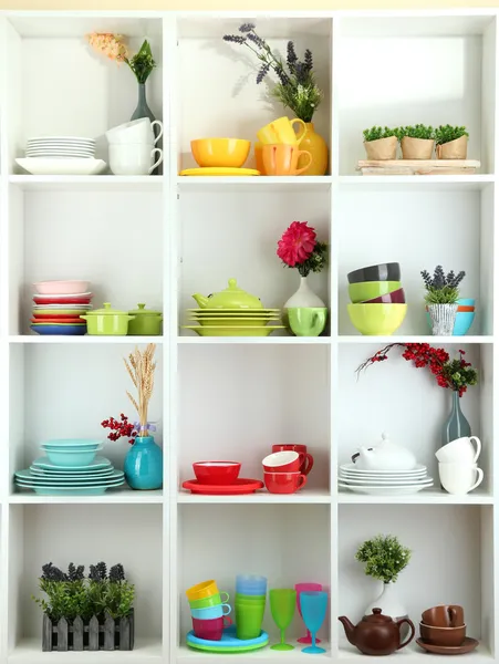 Beautiful white shelves with tableware and decor