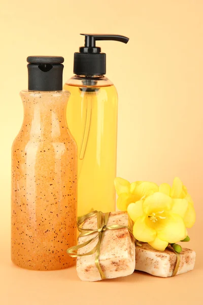 Liquid and hand-made soaps on beige background