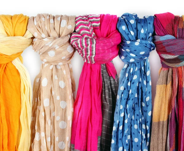 Many bright female scarfs close-up