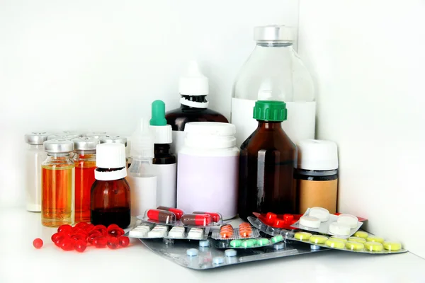 Medical bottles and pills on shelf