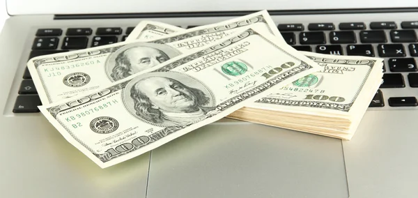 Money on laptop isolated on white — Stock Photo #21495457