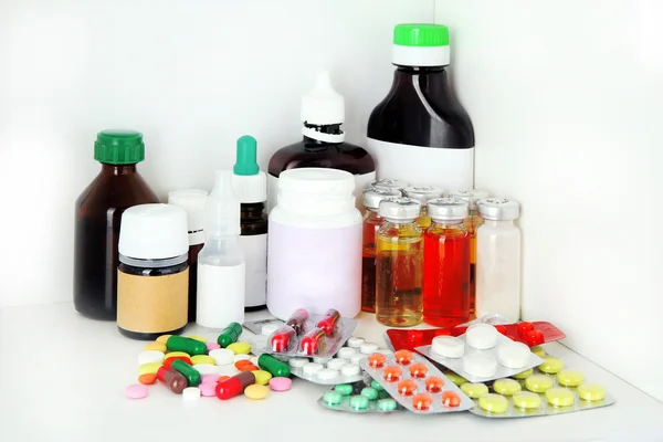 Medical bottles and pills on shelf