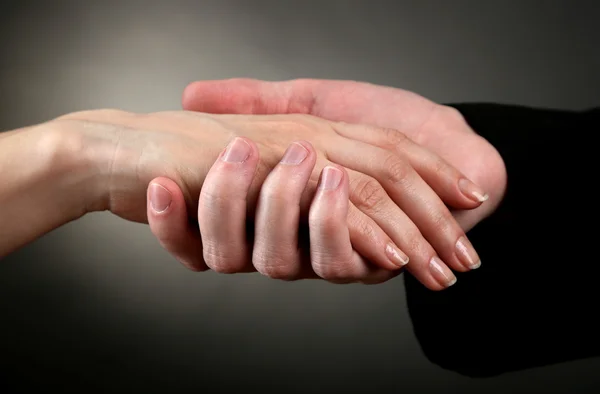 Priest holding woman hand, on black background — Stock Photo #22010301