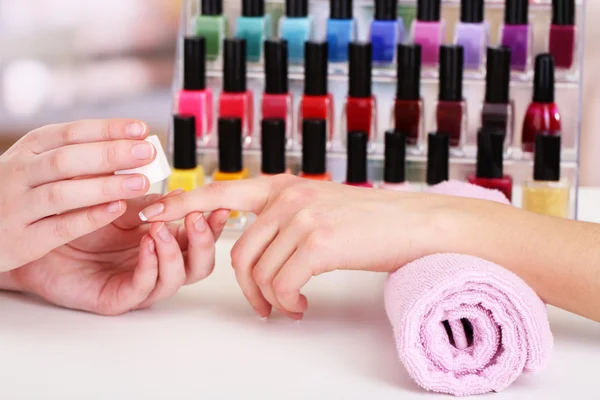 Manicure process in beauty salon, close up