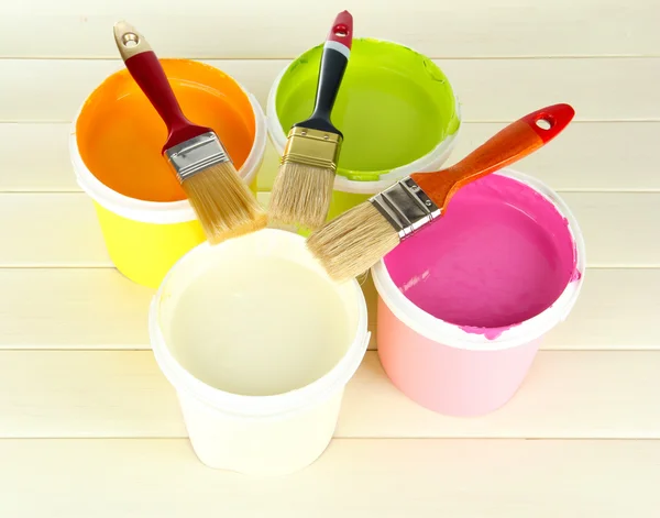 Set for painting: paint pots, brushes on white wooden table