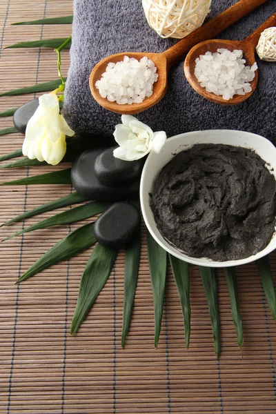 Composition with cosmetic clay for spa treatments, on bamboo background