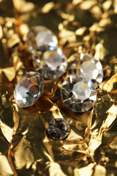 Beautiful shining crystals (diamonds), on golden background