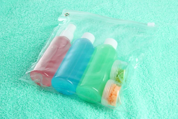 Hotel cosmetics kit on blue towel