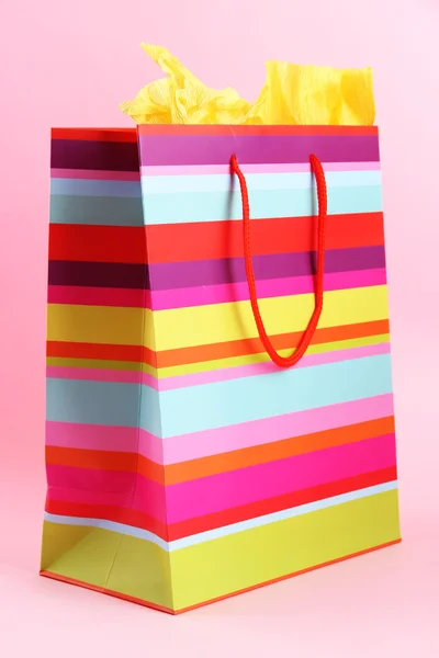Striped shopping bag on pink background — Stock Photo #24129993