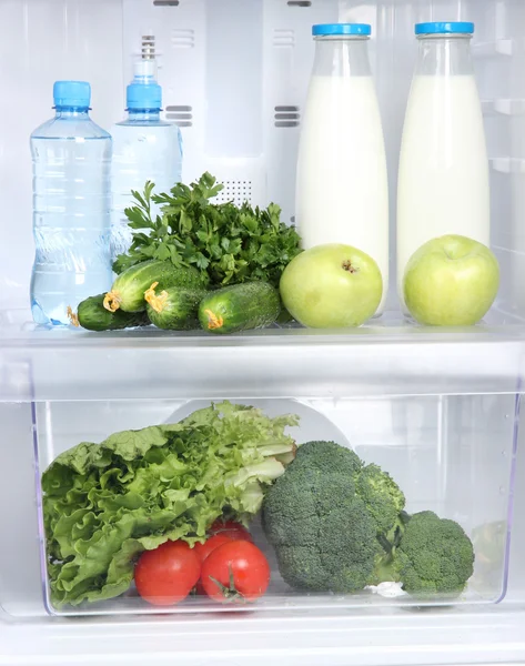 Open refrigerator with vegetarian food