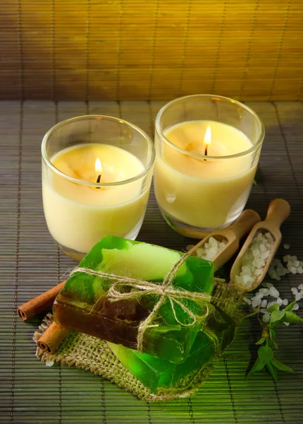 Hand made soap and candles on bamboo mat background