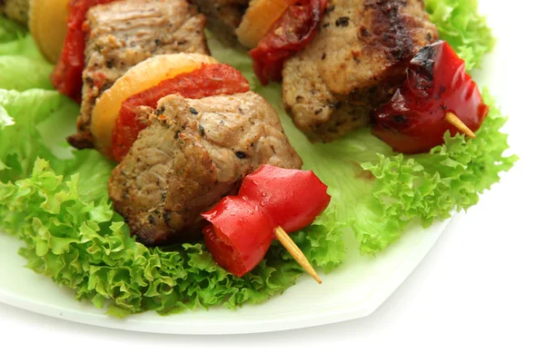 Tasty grilled meat and vegetables on skewers on plate, isoalted on white