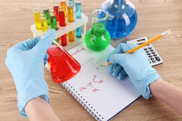 Hand scientist writing formulas