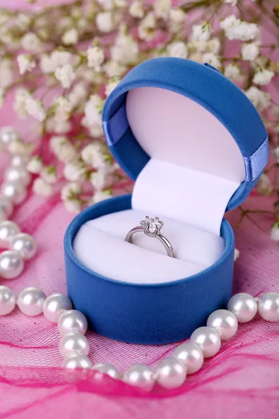 Engagement ring on pink cloth