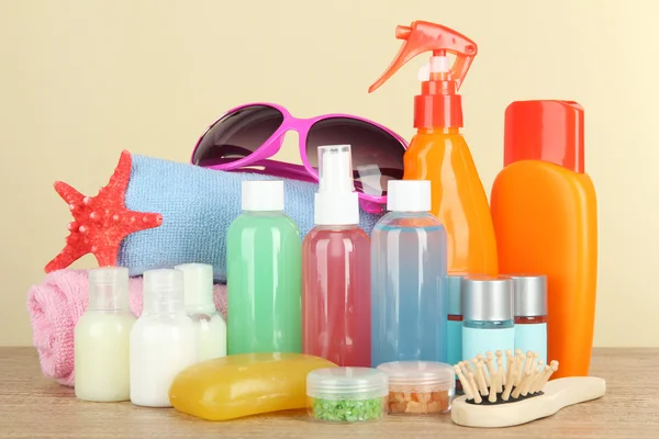 Hotel amenities kit on table on beige background