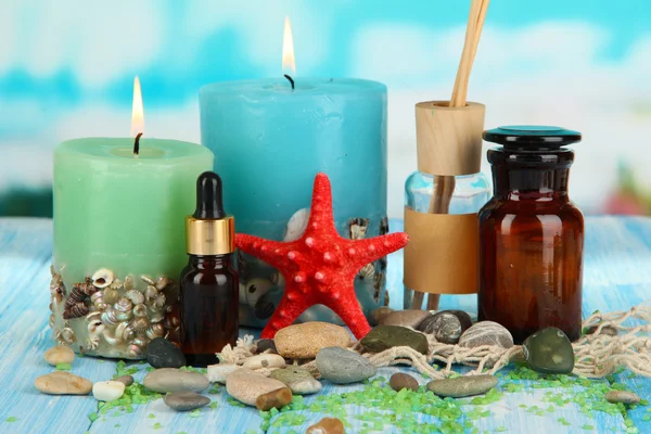 Sea spa composition on wooden table on blue natural background