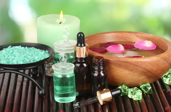 Spa composition with aroma oils on table on bright background