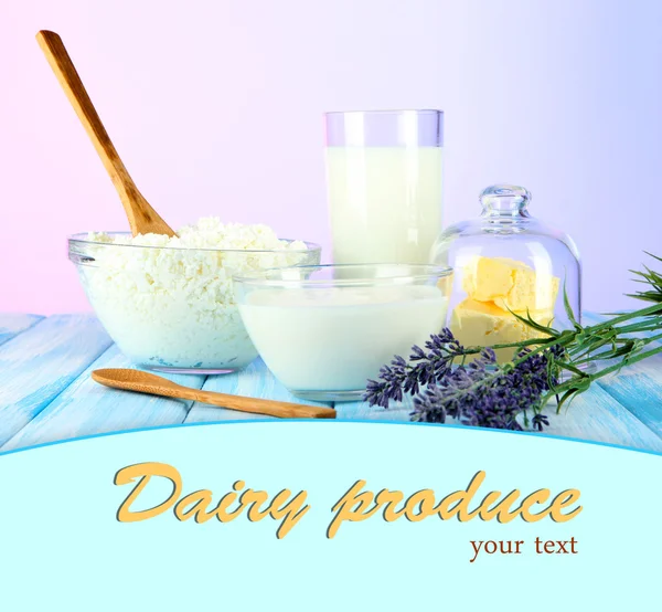 Glass of milk and cheese on table on light background