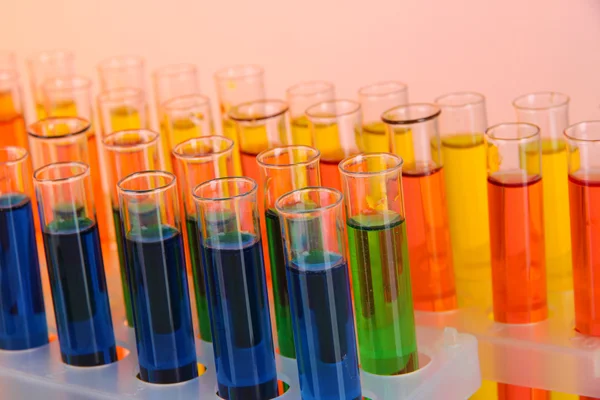 Colorful test tubes on light background