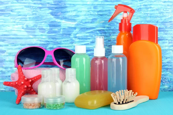 Hotel cosmetics kit on bright color background