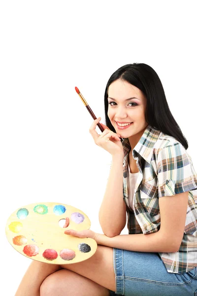 Beautiful young woman painter with brushes and palette, isolated on white